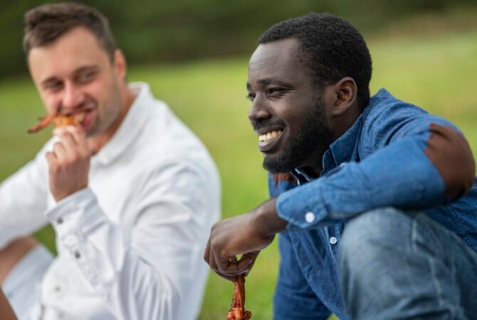 male-friends-outdoors-eating-barbecue