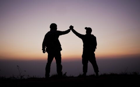 Silhouette of Teamwork helping hand trust help